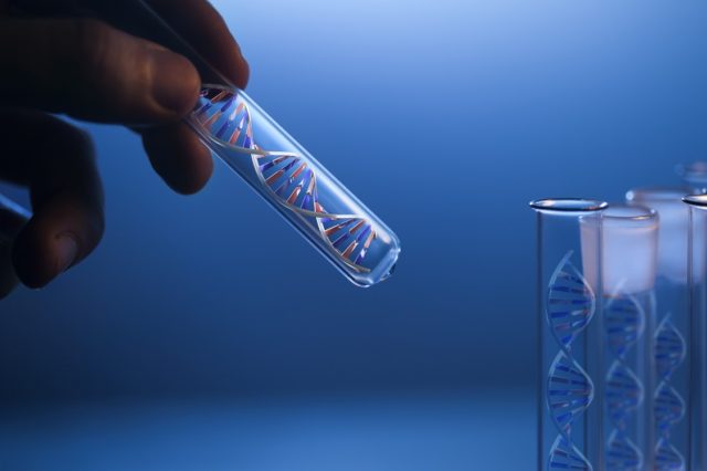 DNA molecule in glass tube in hand of scientist
